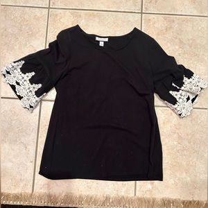 Black blouse with white accents on the sleeves